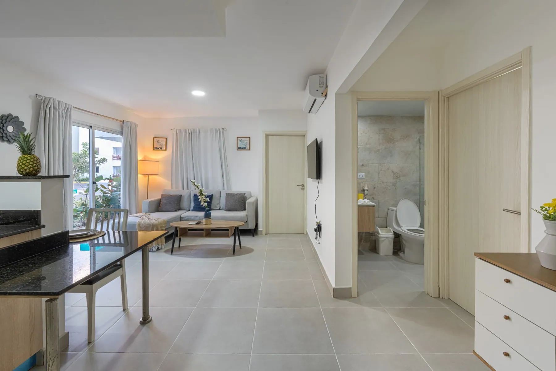 Wide view of the living area looking down the hallway toward the bedrooms and guest bathroom