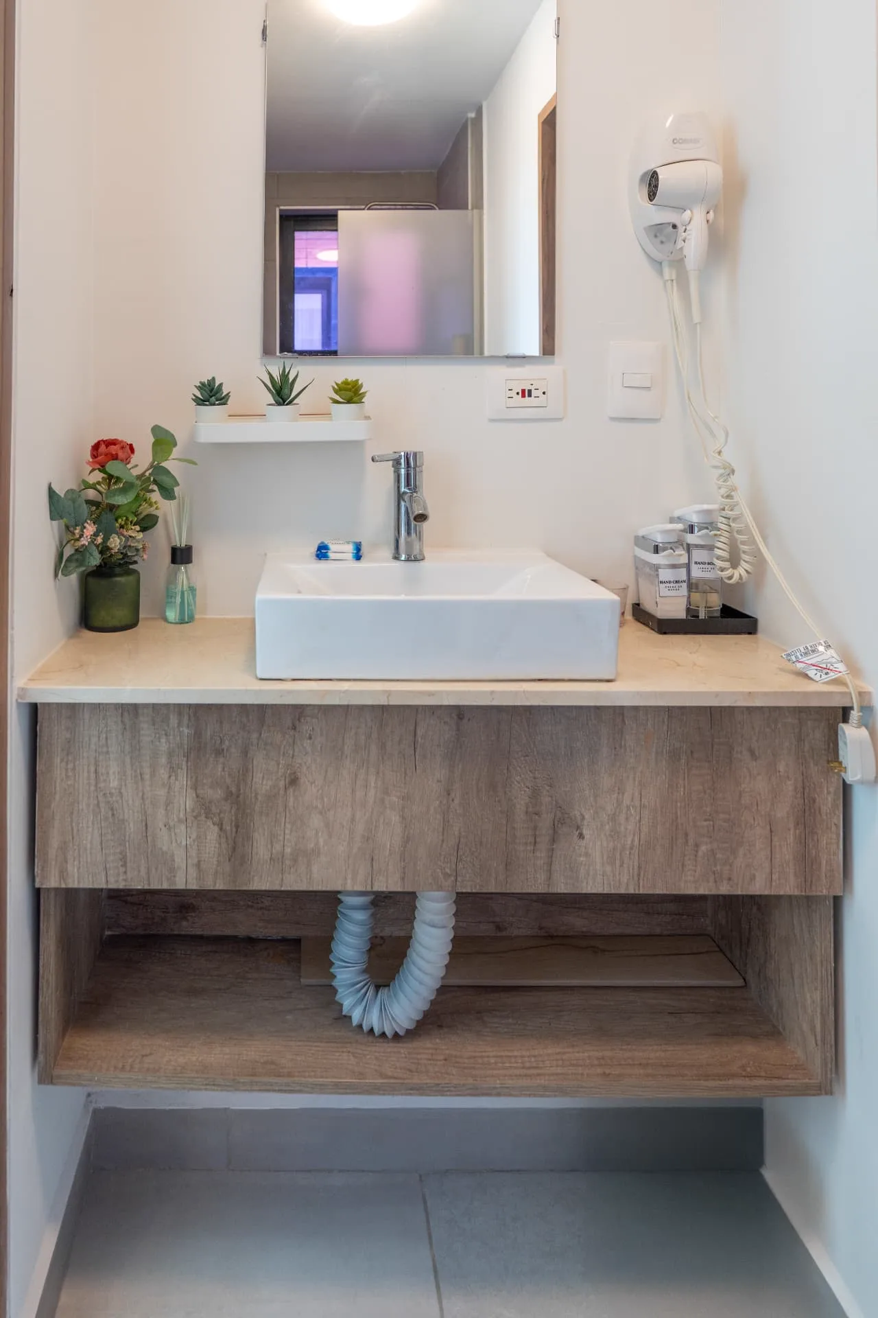 Bathroom vanity with marble top, vessel basin and floating oak cabinet
