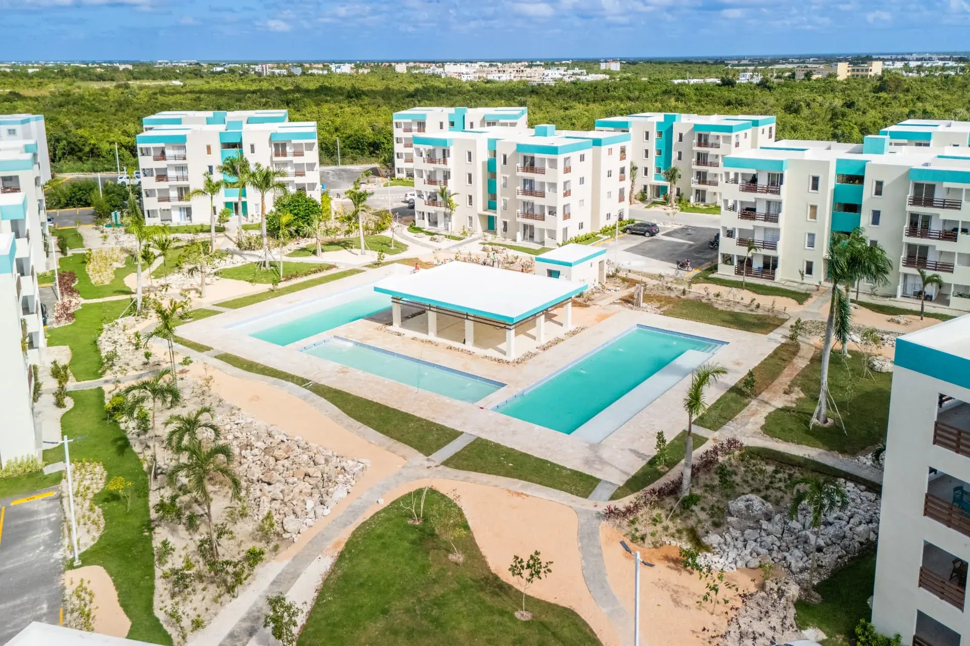 Aerial view of the amenity core with twin pools, shade pavilion and surrounding condominium blocks