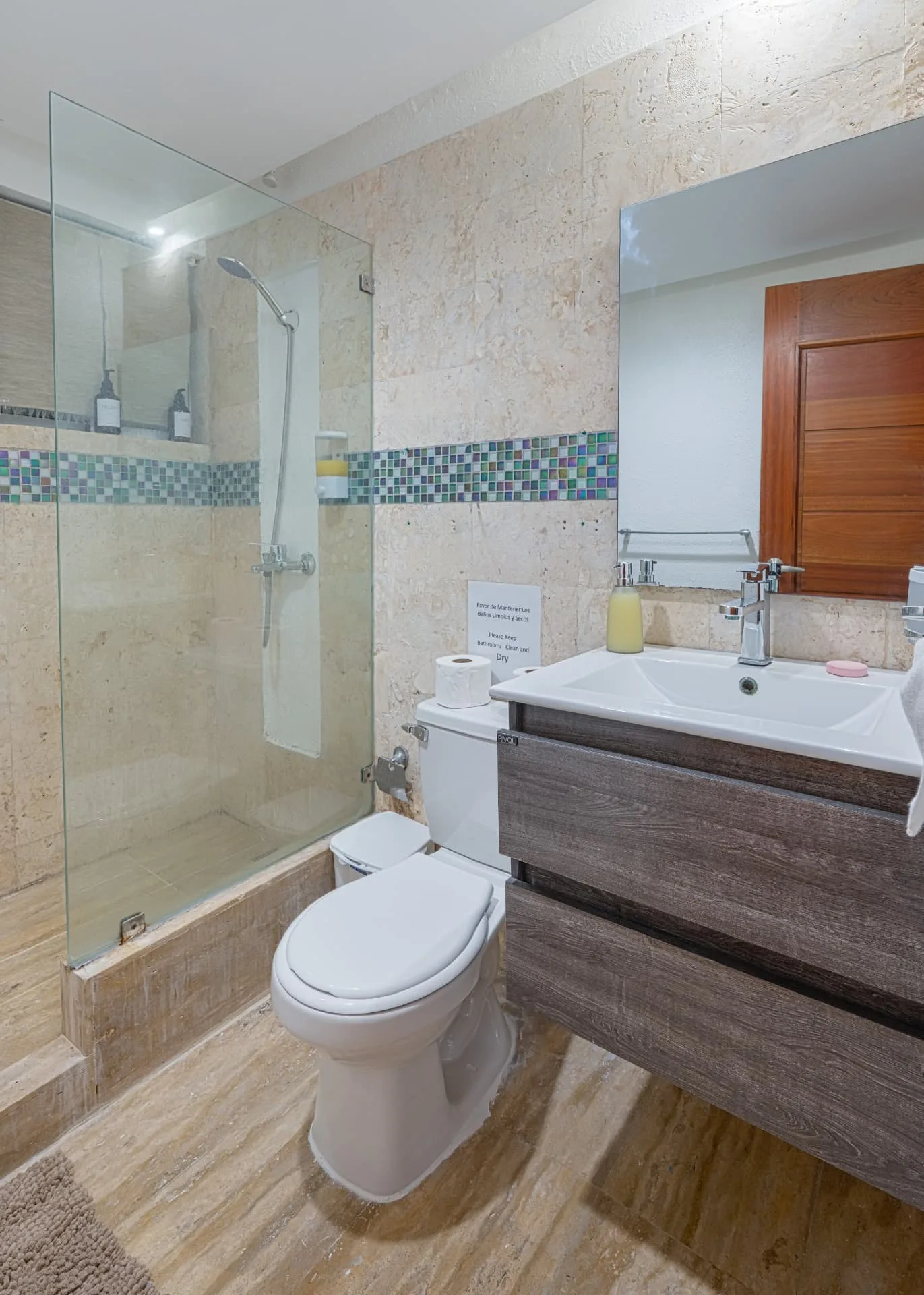 Second bathroom with glass shower enclosure, green mosaic tile band, wide mirror and floating vanity