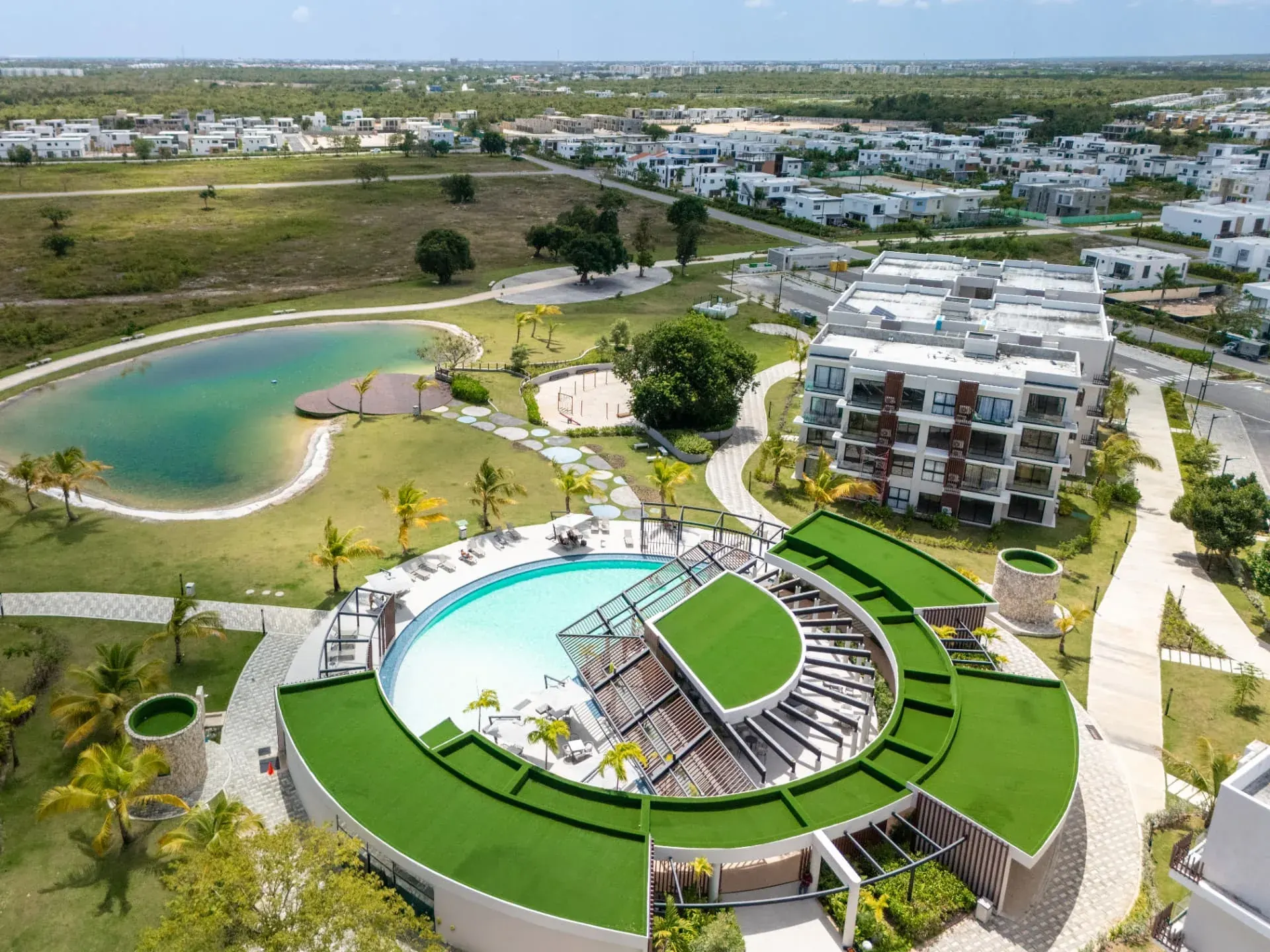 Aerial view of a residential community with clubhouse, pool and swimming lagoon