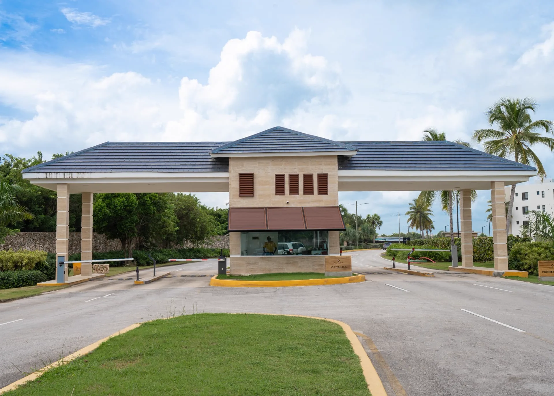 Vista Cana gated community guardhouse with travertine columns and slate roof